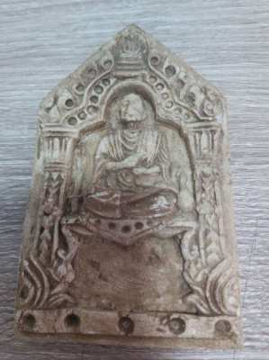 A old Thai plaque showing a monk