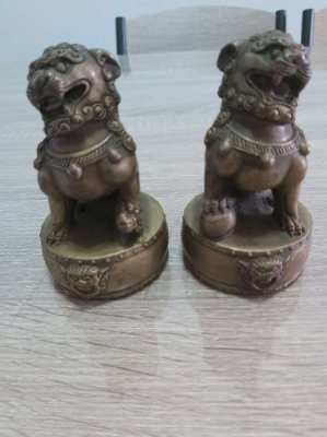 A pair of chinese bronze foo dogs on circular bases mark to base