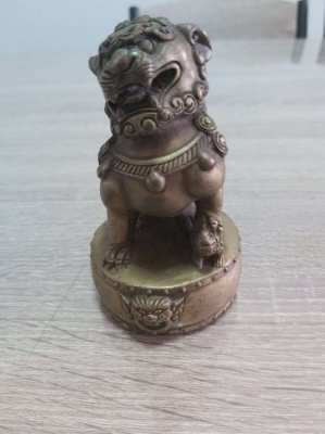 A pair of chinese bronze foo dogs on circular bases mark to base