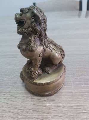 A pair of chinese bronze foo dogs on circular bases mark to base