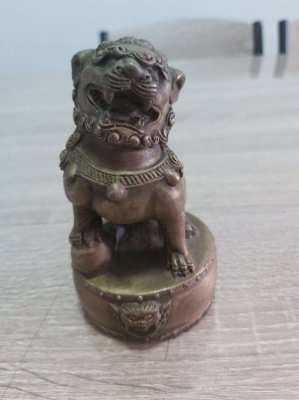 A pair of chinese bronze foo dogs on circular bases mark to base