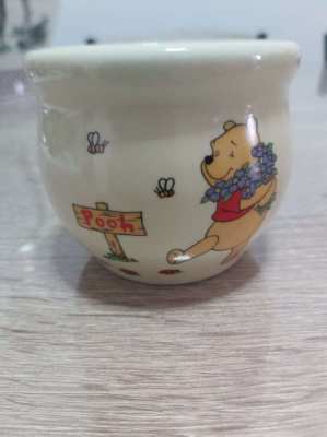 A set of 4 highly collectable Disney winnie the pooh honey pots