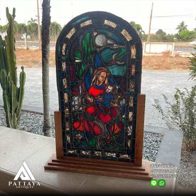 Antique stained glass Virgin Mary on woodenstand