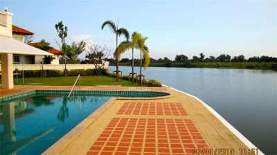 Large lake side pool home in exclusiive gated community