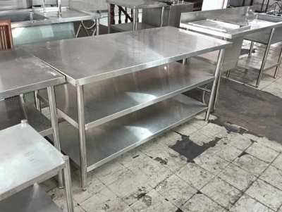 Stainless steel table under shelves